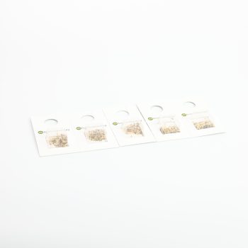 set of diverse stud earrings on white display cards against a white background