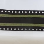 Black and green timing belt with perforated edges on a white background.