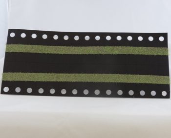 Black and green timing belt with perforated edges on a white background.